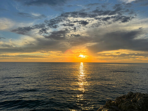 Sunset sky over calm ocean 