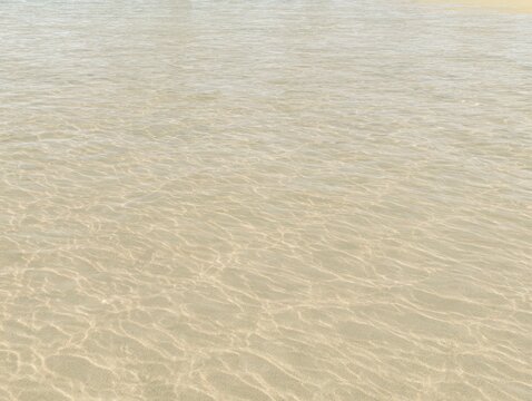 Clear shallow water with sandy bottom