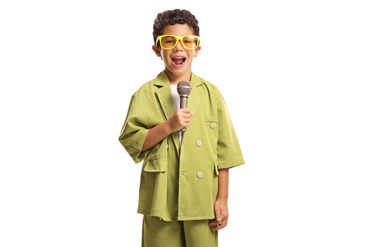 Boy in a green suit and yellow sunglasses holding a microphone and singing