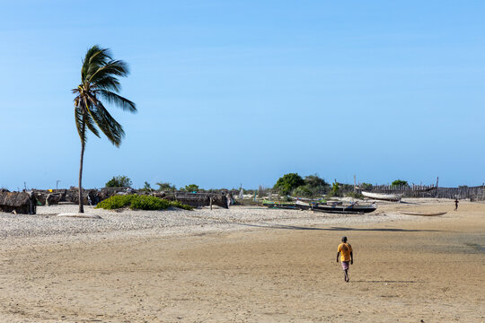 Vezo man walking alone on an empty beach, Belo sur Mer, Madagascar