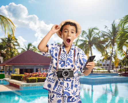 Boy holding a phone and wearing a straw hat