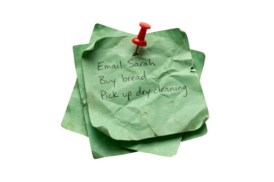 Handwritten sticky note with to-do list pinned on crumpled paper