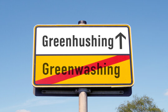 Concept of greenhushing vs greenwashing on a german road sign
