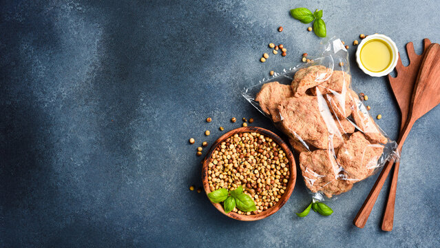 Raw soya chunks, soy meat for vegans in a package. Food nutrition concept.