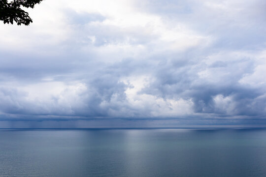 view of calm Black Sea under cloudy sky in Batumi