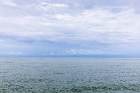 cloudy sky over water of Batumi Bay of Black Sea
