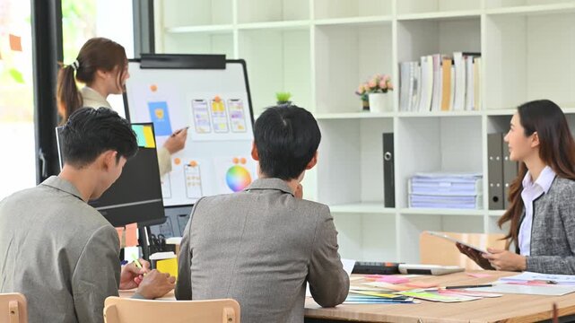 Young Gen Z Asian Developer Team Presenting Mobile App UI UX Design in Modern Creative Office
