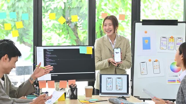 Young Gen Z Asian Developer Team Presenting Mobile App UI UX Design in Modern Creative Office