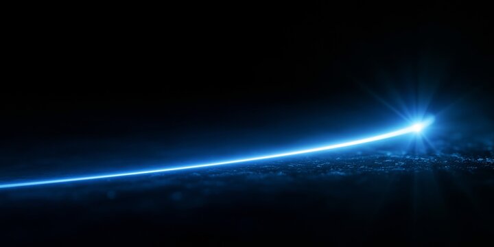 Blue glowing light streak on dark surface