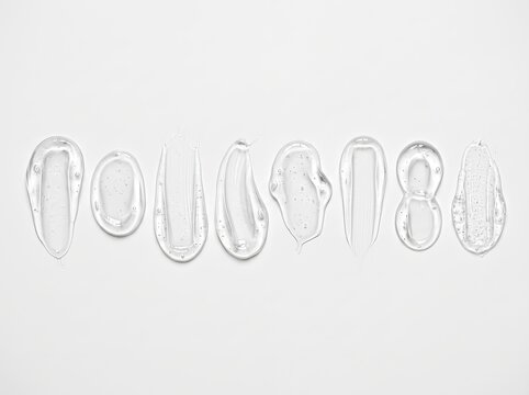 Set of clear transparent cosmetic gel smears and serum swatches in a row on white background, skincare texture
