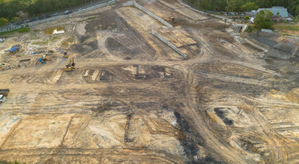 High angle aerial view of a large scale construction site and land development project with heavy machinery excavators clearing the ground for new © Muhammad