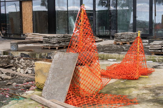 Orange safety barrier net and warning mesh on building construction site