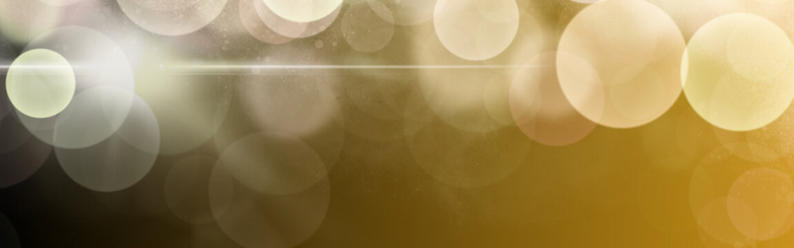 Golden shimmering bokeh lights forming a festive abstract background, celebrating holidays and special occasions with sparkling glitter and a bright lens flare beam effect