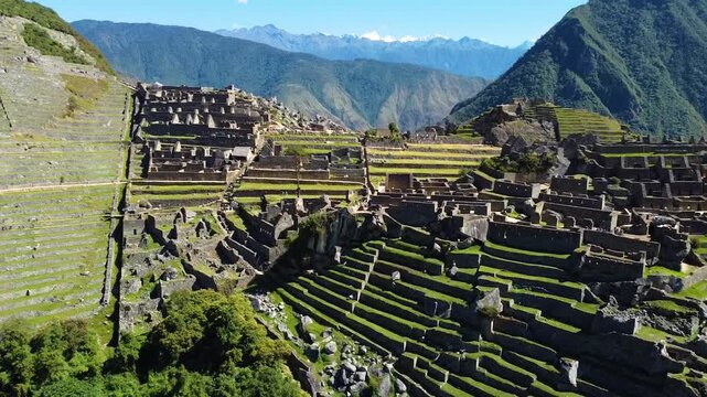 Aerial view of the ancient Inca ruins of the Historic Sanctuary of Machu Picchu with stone terraces and mountains in Urubamba Province, Cusco, Peru.