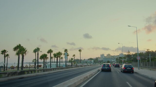 Lisbon, Portugal 07.25.2026 Cruising down Avenida Marginal, where the road meets the ocean in Lisbon. 
