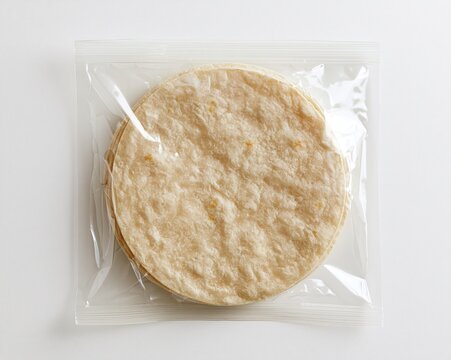 Plain, round tortillas in clear plastic packaging.