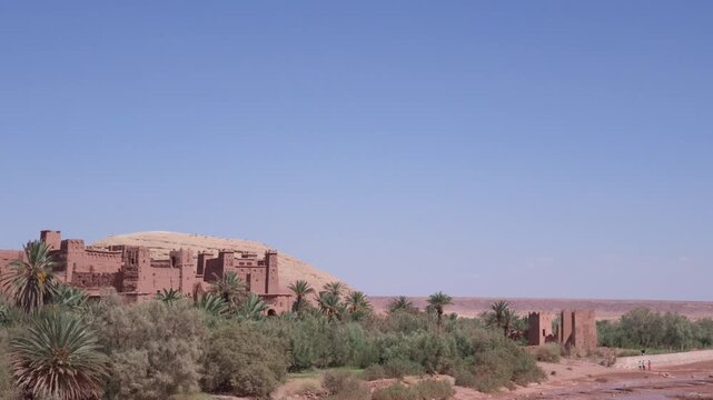 Scenic panoramic view of the ancient ksar of ait benhaddou in morocco, a traditional mud-brick fortress in the atlas mountains on a sunny day with clear blue sky
