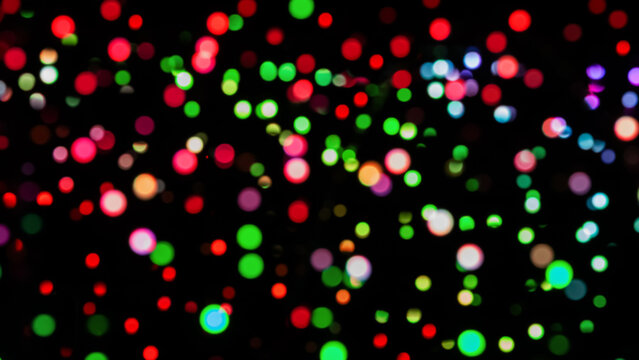 Vibrant multi colored bokeh lights shimmer on a dark background, creating a festive, dreamy atmosphere. The abstract glow celebration, mood, and energy, ideal for holiday, party, or nightlife visuals.