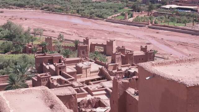 Scenic aerial view of the ksar of ait benhaddou in morocco, revealing the ancient berber kasbah architecture, mud brick houses, and the surrounding desert landscape