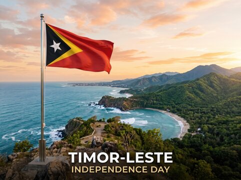 The national flag of timor leste waving on a metal pole above a tropical coastal headland with green mountains and a blue ocean bay during a golden sunset sky