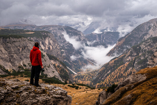 hombre mirando un paisaje frio y monta&ntilde;oso con nubes