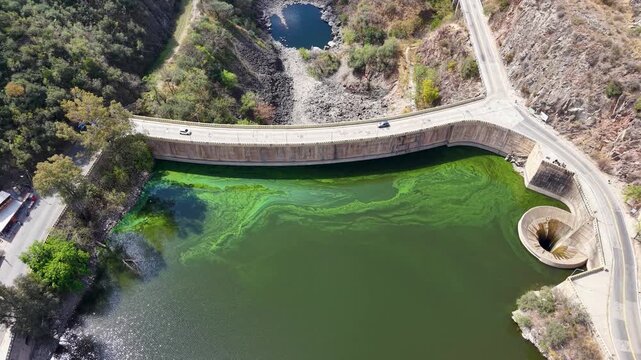 Scenic overhead drone video of Dique San Roque dam and spillway funnel in Argentina