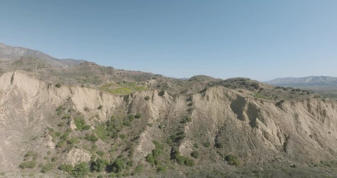 Aerial view flying over an eroded badlands ridge