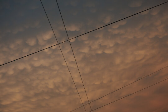 Colorful Sky With Clouds and Power Lines at Sunset In City