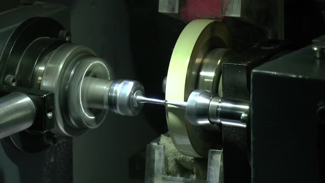 diamond polishers at work at the wheel in the diamond polishing factory. The process of finishing a diamond blank using a roughing wheel.
