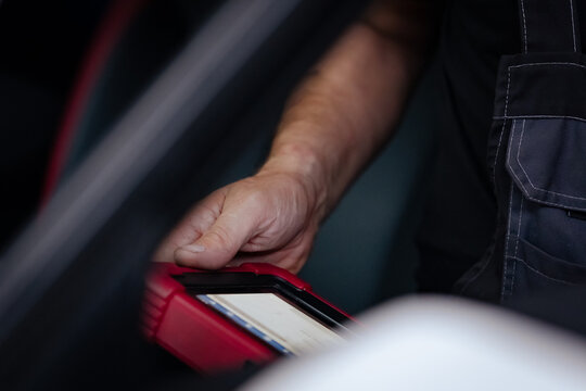 Mechanic Holding Diagnostic Tablet