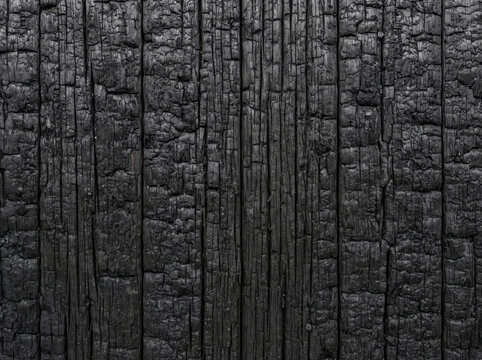 Burnt charred wood texture dark vertical grain rustic industrial background weathered surface