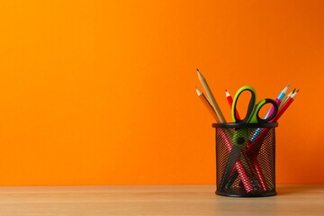 Black holder with stationery on table, closeup. © Sunlight