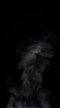 White natural rising steam from food or hot drink isolated on a black background. Сan be used in any projects with hot food.