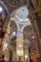 Naklejka premium Ornate carved domes and columns in historic church interior, Granada