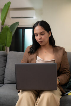 Young woman working from home using laptop