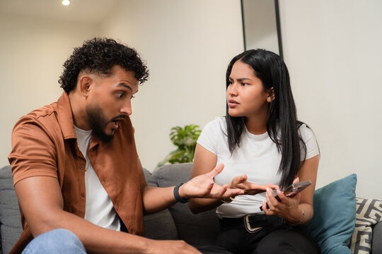Young couple having serious discussion about relationship problem