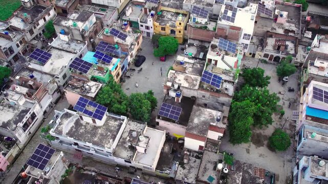 Aerial view of rooftop solar panels installed on residential buildings in a neighborhood in Lucknow, Uttar Pradesh, India.