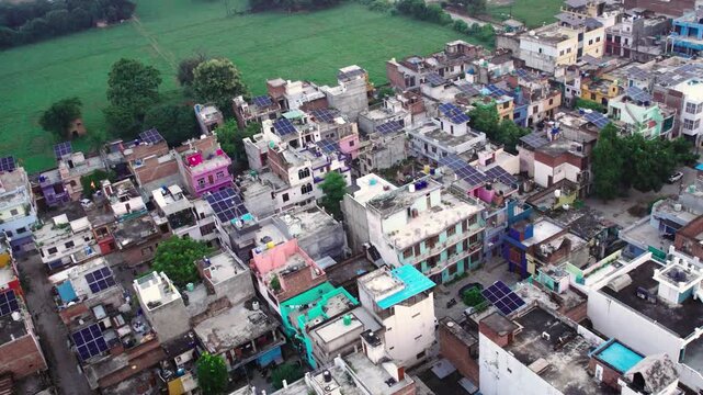 Aerial view of a residential neighborhood featuring a solar scheme with panels installed on rooftops in Lucknow, Uttar Pradesh, India.