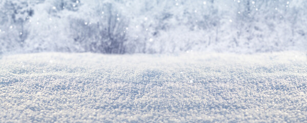 Textured snow cover close-up on a blurred background of a winter forest. Fresh snow crystals and hoarfrost sparkling in the sun. Winter panoramic background. Light and clean winter landscape. Nature © Mariia