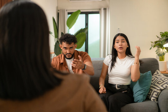 Couple discussing problems during counseling session at home