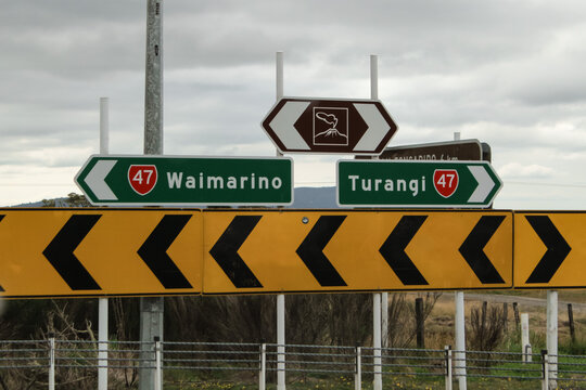 road signs on State Highway 47 in New Zealand, pointing left toward Waimarino and right toward Turangi. transportation theme