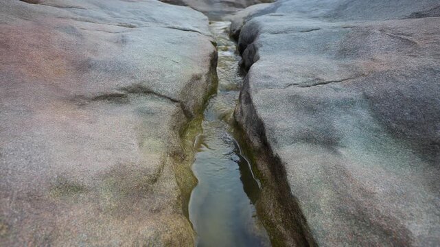 岩の割れ目から染み出す地下水 シームレスループ動画背景 16:9 4K