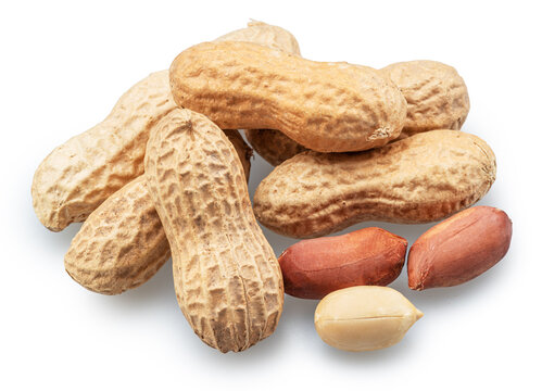Group of whole and cracked peanuts isolated on a white background.