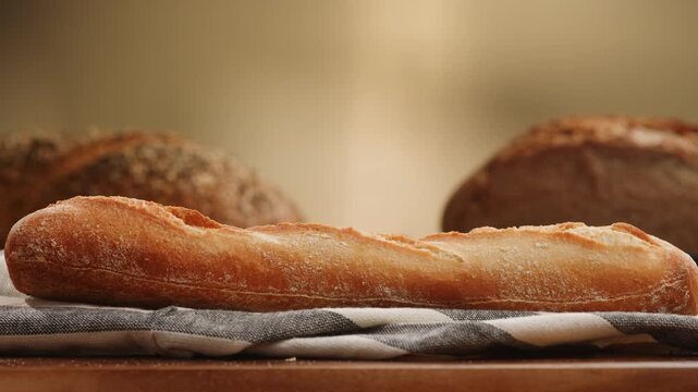 Bread assortment close up, rustic sourdough loaf, whole grain seed bread and baguette on Mediterranean table, knife cutting artisan bread, Italian bakery