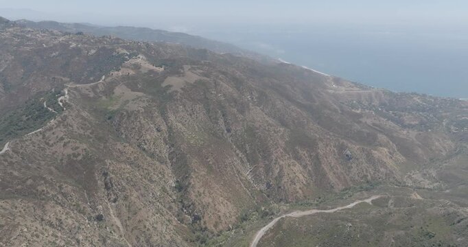 Aerial view of coastal mountain ridges with ocean haze