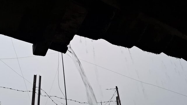 rainwater pouring from roof