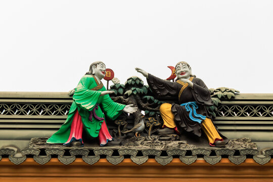 Traditional Chinese Roof Sculpture of Two Smiling Figures in Shanghai