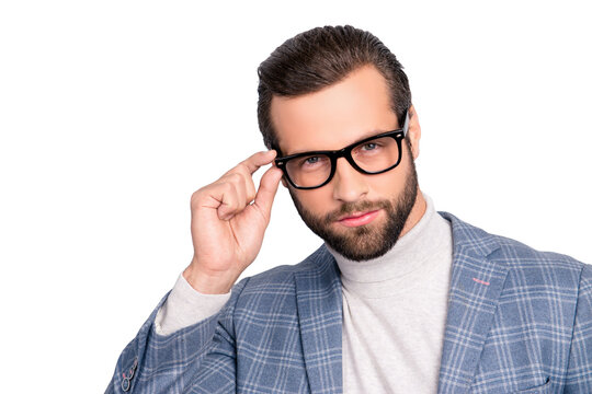 Portrait of gentlemen, manly, stunning, dreamy, inteligent man holding eyelet of glasses on his face with fingers, looking at camera over gray background