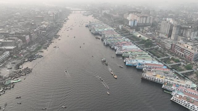 Aerial view of Sadarghat river port with numerous passenger ferries and boats docked along the Buriganga River in Dhaka, Dhaka Division, Bangladesh.
