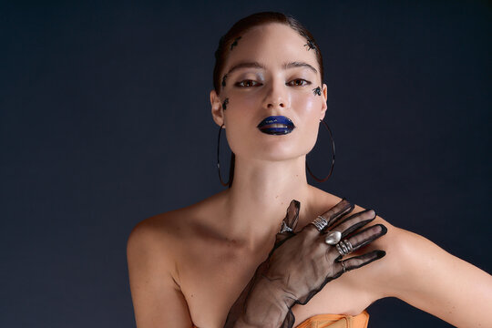 Striking blue lips and creative Halloween makeup on a beautiful woman